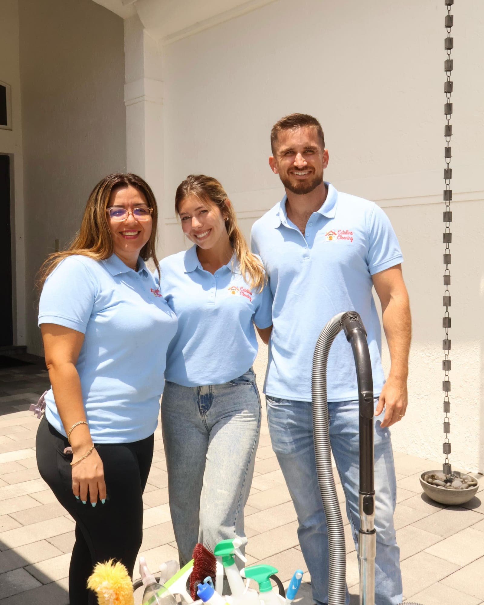 The Catalina Cleaning team outside a Miami home with their cleaning cart and equipment